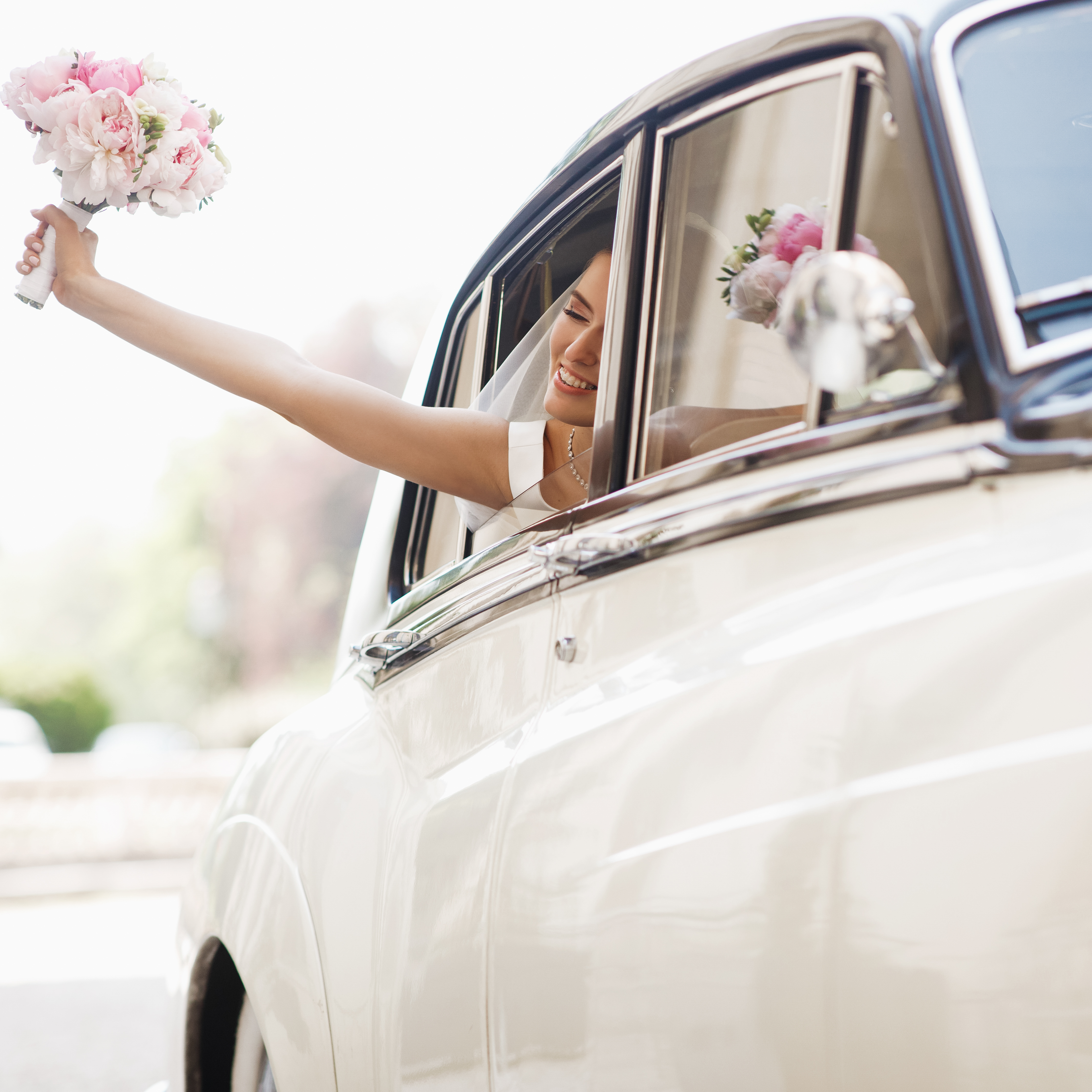 beautiful-bride-sits-with-wedding-bouquet-retro-car-has-fun